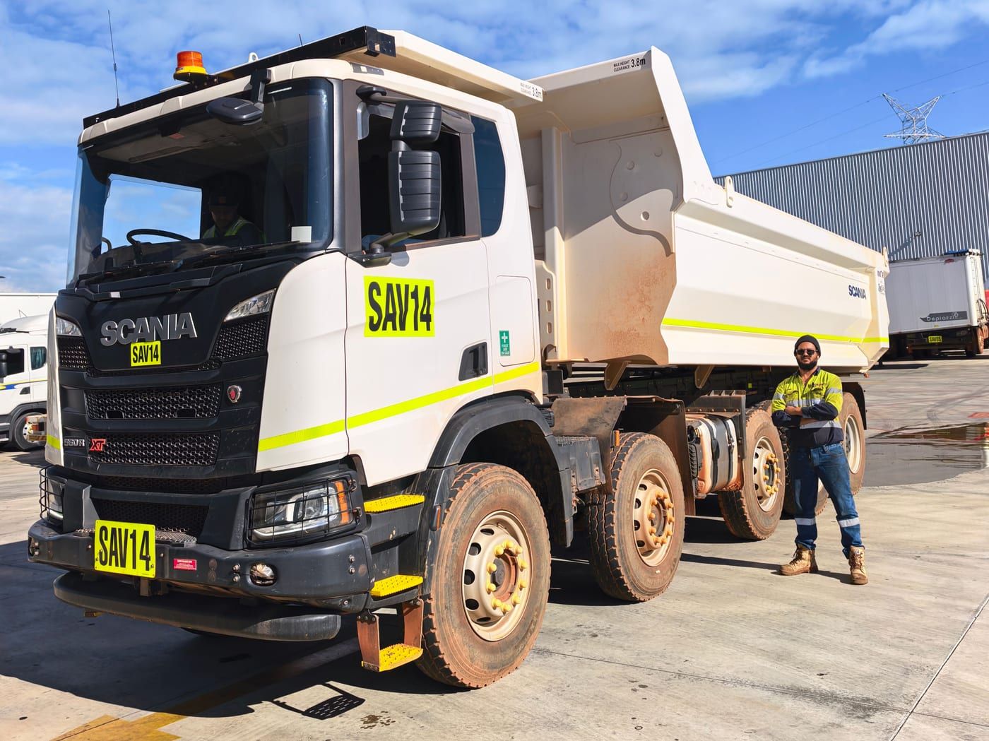 Cowan on site beside a Scania heavy tipper truck